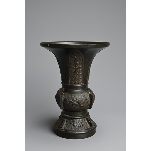 273 - A CHINESE BRONZE GU VASE, QING DYNASTY. With wide flared mouth decorated to the foot and mid section... 