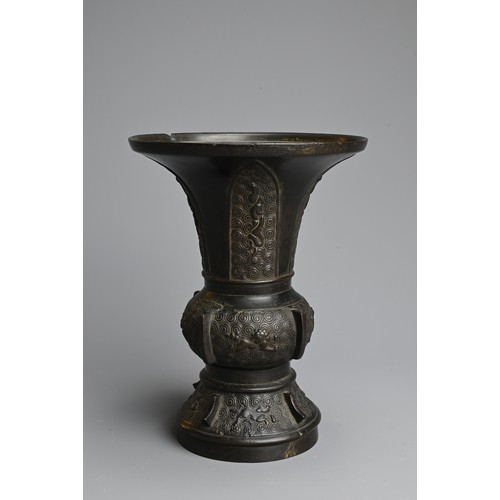 273 - A CHINESE BRONZE GU VASE, QING DYNASTY. With wide flared mouth decorated to the foot and mid section... 