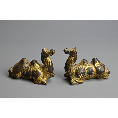 282 - A GROUP OF CHINESE POLISHED AND GILT BRONZE ITEMS. To include three gilt models of recumbent camels;... 