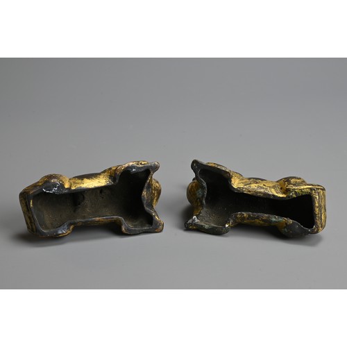 282 - A GROUP OF CHINESE POLISHED AND GILT BRONZE ITEMS. To include three gilt models of recumbent camels;... 