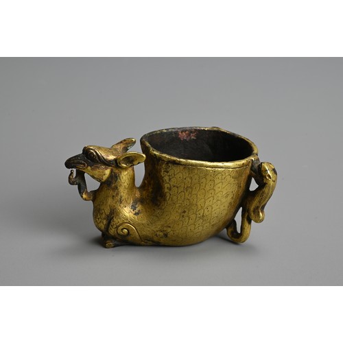 282 - A GROUP OF CHINESE POLISHED AND GILT BRONZE ITEMS. To include three gilt models of recumbent camels;... 