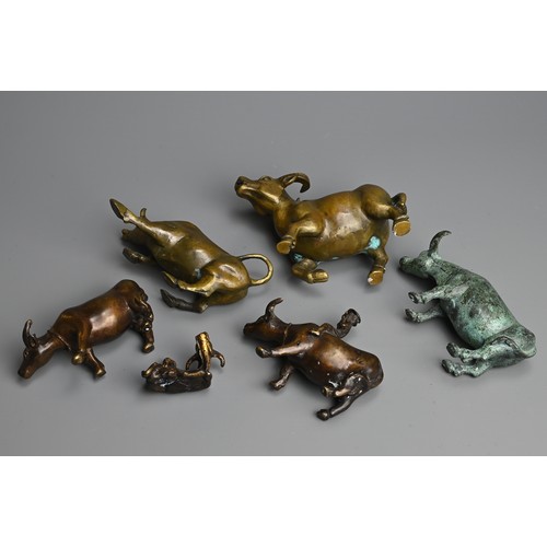 284 - A GROUP OF CHINESE BRONZE MODELS OF BUFFALO, 20TH  CENTURY. Of various sizes, two modelled with boys... 