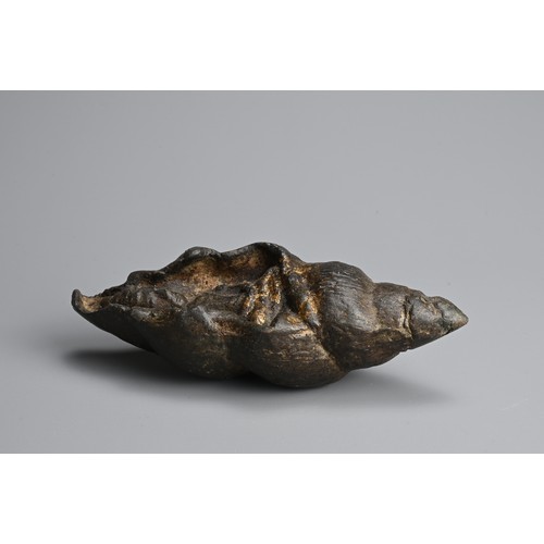 292 - A SOUTHEAST ASIAN BRONZE FIGURE OF BUDDHA IN CONCH SHELL. The figure seated in meditation within a c... 