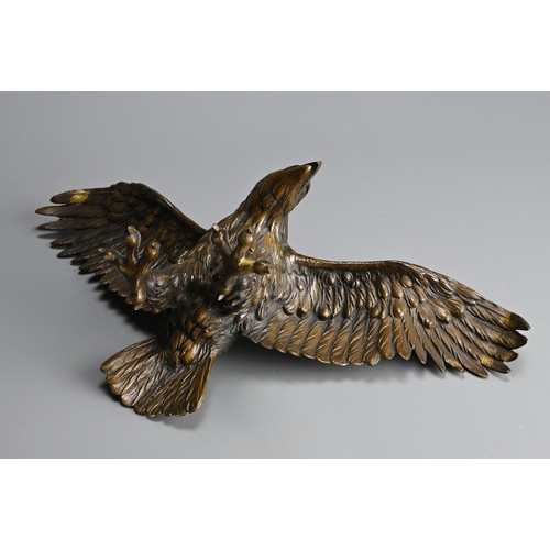 296 - A JAPANESE CAST BRONZE MODEL OF AN EAGLE, 19/20TH CENTURY. Well cast, standing with its wings spread... 