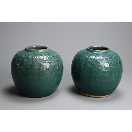 322 - A PAIR OF CHINESE TURQUOISE GLAZED STONEWARE JARS. Of globular form with moulded decoration around t... 