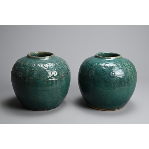 322 - A PAIR OF CHINESE TURQUOISE GLAZED STONEWARE JARS. Of globular form with moulded decoration around t... 