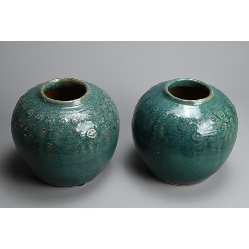 322 - A PAIR OF CHINESE TURQUOISE GLAZED STONEWARE JARS. Of globular form with moulded decoration around t... 