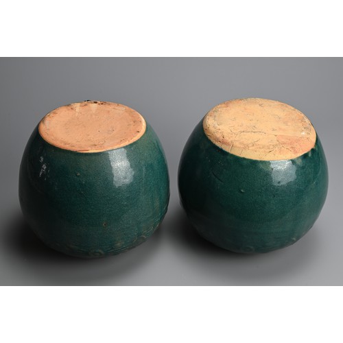 322 - A PAIR OF CHINESE TURQUOISE GLAZED STONEWARE JARS. Of globular form with moulded decoration around t... 