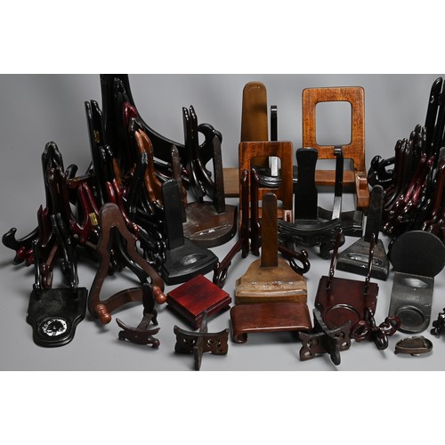 350 - A QUANTITY OF CHINESE WOOD DISPLAY STANDS. To include fifty eight folding plate stands, together wit... 