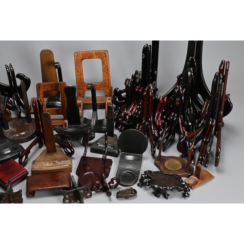 350 - A QUANTITY OF CHINESE WOOD DISPLAY STANDS. To include fifty eight folding plate stands, together wit... 