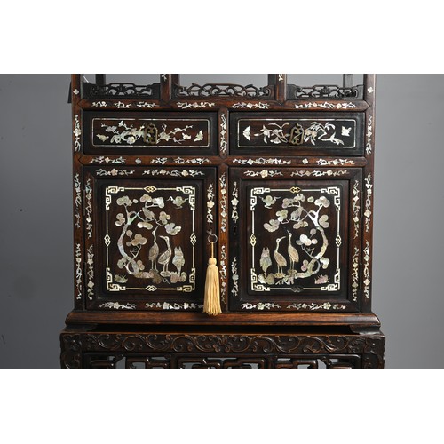 339 - A TALL CHINESE HARDWOOD INLAID DECORATED DISPLAY CABINET, EARLY 20TH CENTURY. In two sections compri... 