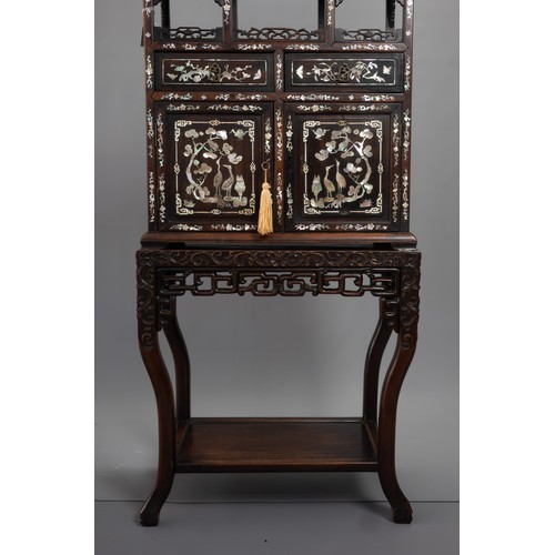 339 - A TALL CHINESE HARDWOOD INLAID DECORATED DISPLAY CABINET, EARLY 20TH CENTURY. In two sections compri... 