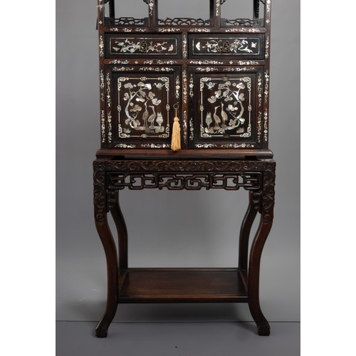 339 - A TALL CHINESE HARDWOOD INLAID DECORATED DISPLAY CABINET, EARLY 20TH CENTURY. In two sections compri... 