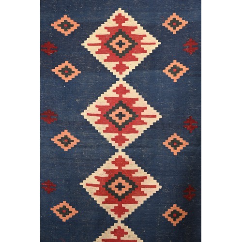 336 - AN AFGHAN FLATWEAVE KILIM RUG, 20TH CENTURY. Woven with bold diamond lozenges within a geometric bor... 