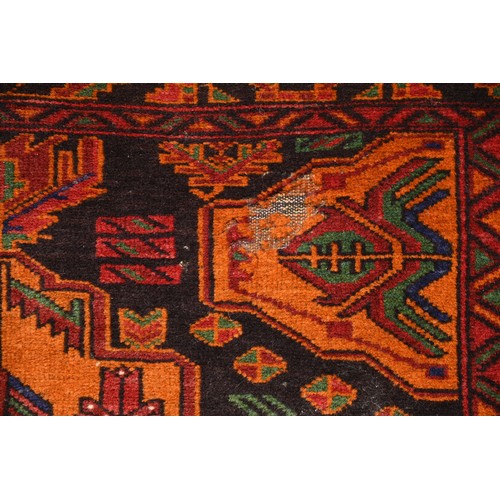 337 - AN AFGHAN CAMEL WOOL RUG, 20TH CENTURY. With geometric roundels enclosing foliate motifs predominate... 