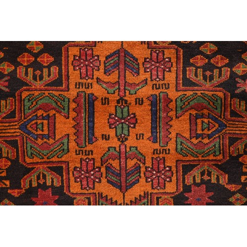 337 - AN AFGHAN CAMEL WOOL RUG, 20TH CENTURY. With geometric roundels enclosing foliate motifs predominate... 