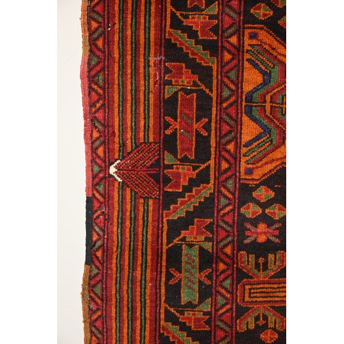 337 - AN AFGHAN CAMEL WOOL RUG, 20TH CENTURY. With geometric roundels enclosing foliate motifs predominate... 