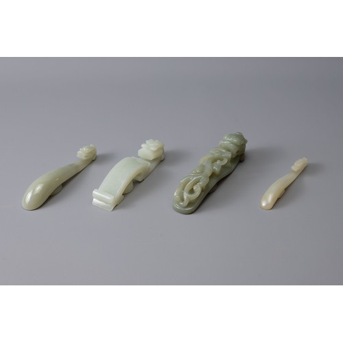 312 - FOUR CHINESE PALE CELADON DRAGON FORM BELT HOOKS, of various sizes, largest approx. 10 cm long (4)