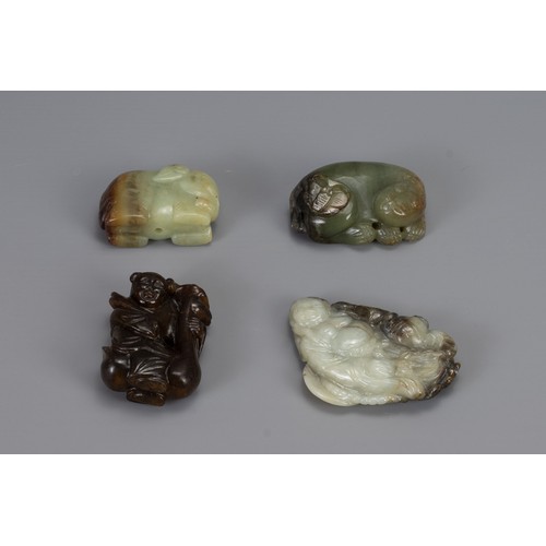 319 - FOUR CHINESE CARVED JADE ITEMS, of different forms to include Liu Hai, recumbent lion with butterfly... 