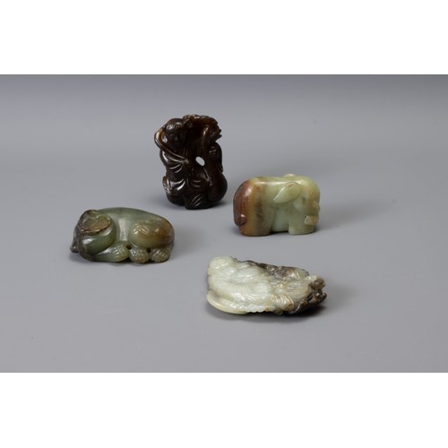 319 - FOUR CHINESE CARVED JADE ITEMS, of different forms to include Liu Hai, recumbent lion with butterfly... 