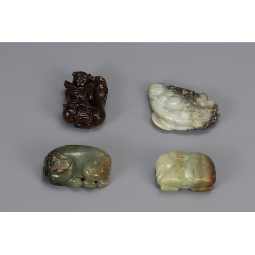 319 - FOUR CHINESE CARVED JADE ITEMS, of different forms to include Liu Hai, recumbent lion with butterfly... 