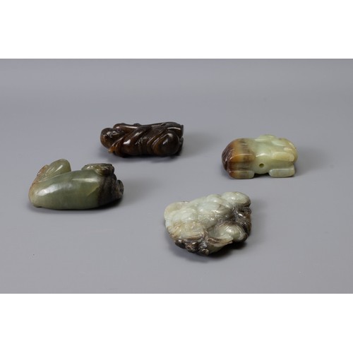 319 - FOUR CHINESE CARVED JADE ITEMS, of different forms to include Liu Hai, recumbent lion with butterfly... 