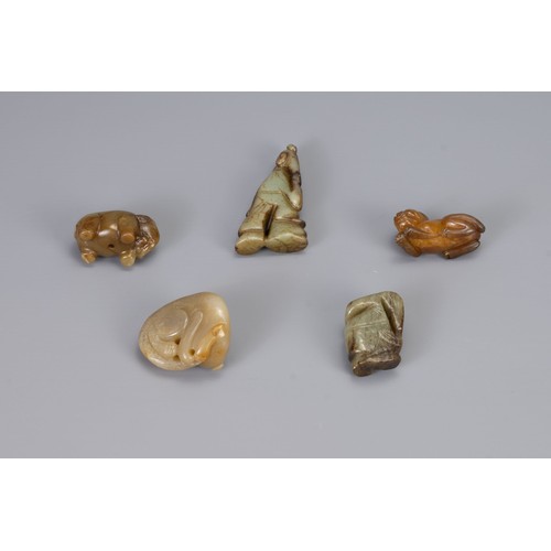 313 - FIVE CHINESE CARVED JADE PENDANTS, of different forms to include a recumbent lion, Liu Hai, recumben... 