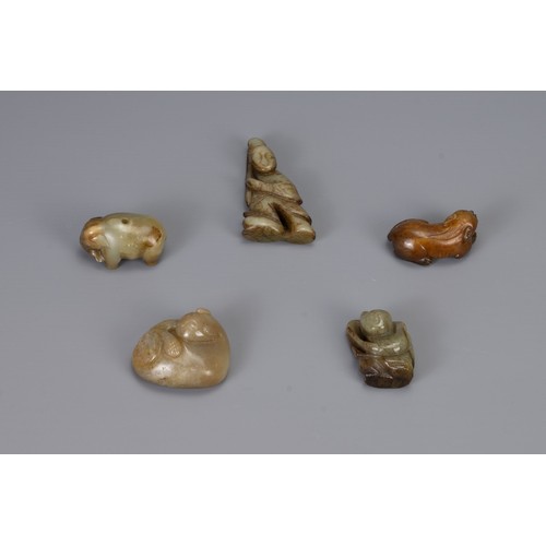 313 - FIVE CHINESE CARVED JADE PENDANTS, of different forms to include a recumbent lion, Liu Hai, recumben... 