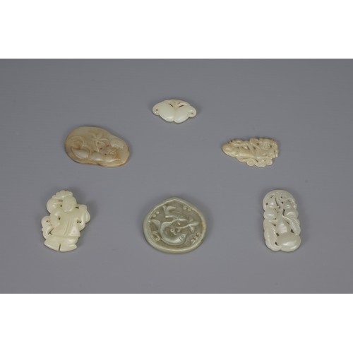 314 - SIX CHINESE CARVED PALE CELADON JADE PENDANTS, of different forms to include hanging double-gourds, ... 