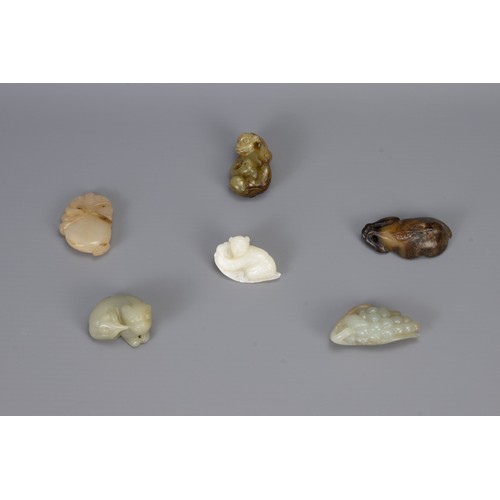 315 - SIX CHINESE CARVED JADE PENDANTS, of different forms to include a bunch of grapes, monkey, boy resti... 