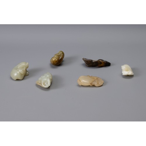 315 - SIX CHINESE CARVED JADE PENDANTS, of different forms to include a bunch of grapes, monkey, boy resti... 