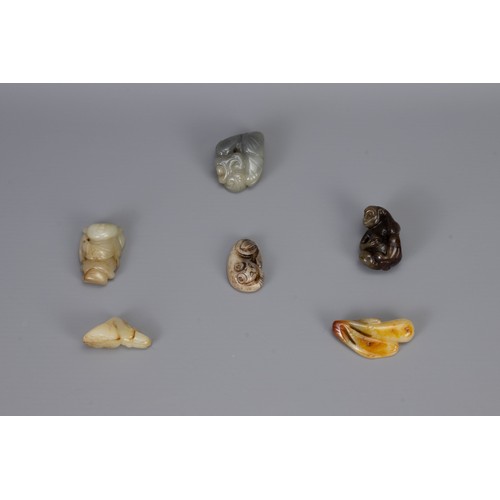 316 - SIX CHINESE CARVED JADE PENDANTS, of different forms to include hanging elongated fruit, monkey with... 