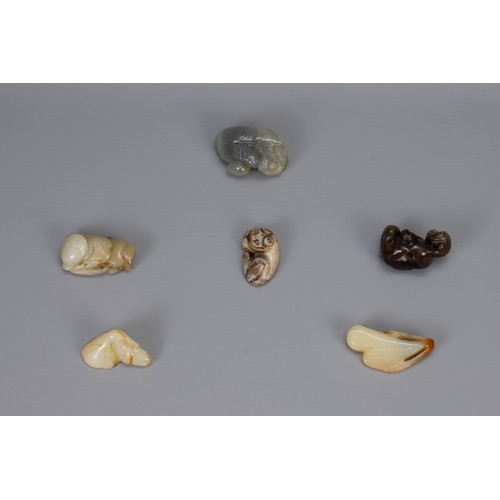 316 - SIX CHINESE CARVED JADE PENDANTS, of different forms to include hanging elongated fruit, monkey with... 