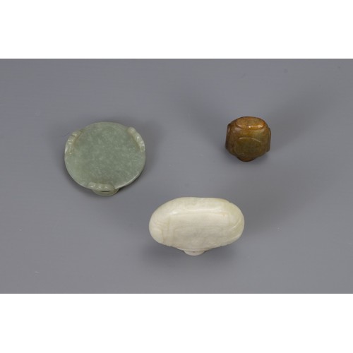 318 - THREE CHINESE CARVED JADE ITEMS, to include two snuff bottles and one brush washer in the form of a ... 