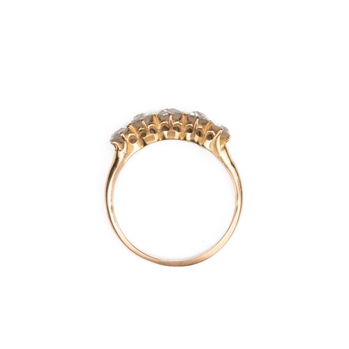 42 - A HIGH CARAT ROSE GOLD DIAMOND RING, MID 20TH CENTURY. With a row of five round cut diamonds. Unmark... 