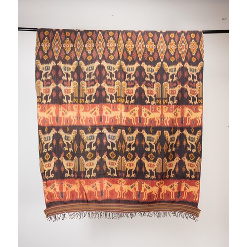 240 - TWO 20TH CENTURY INDONESIAN (SUMBA) COTTON IKAT HINGGI. Each woven in tones of orange, terracotta an... 