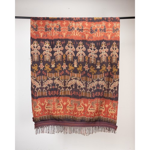 240 - TWO 20TH CENTURY INDONESIAN (SUMBA) COTTON IKAT HINGGI. Each woven in tones of orange, terracotta an... 