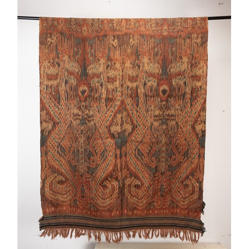 242 - A GROUP OF 20TH CENTURY INDONESIAN TEXTILES. Comprising: a small Sumba cotton ikat, woven with birds... 