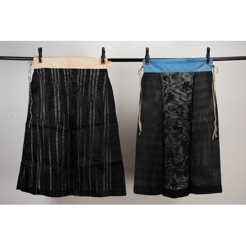 236 - TWO EARLY 20TH CENTURY CHINESE BLACK SILK GAUZE SUMMER SKIRTS. The first with floral embroidering an... 