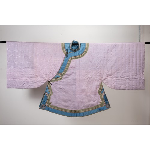 235 - EARLY 20TH CENTURY CHINESE LILAC SILK WINTER ROBE. With flared wide sleeves, edge in blue silk with ... 