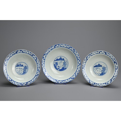 1 - THREE CHINESE BLUE AND WHITE BOWLS, 19TH CENTURY. Shallow rounded sides on a raised foot with everte... 