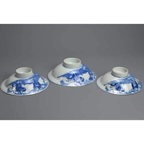 1 - THREE CHINESE BLUE AND WHITE BOWLS, 19TH CENTURY. Shallow rounded sides on a raised foot with everte... 