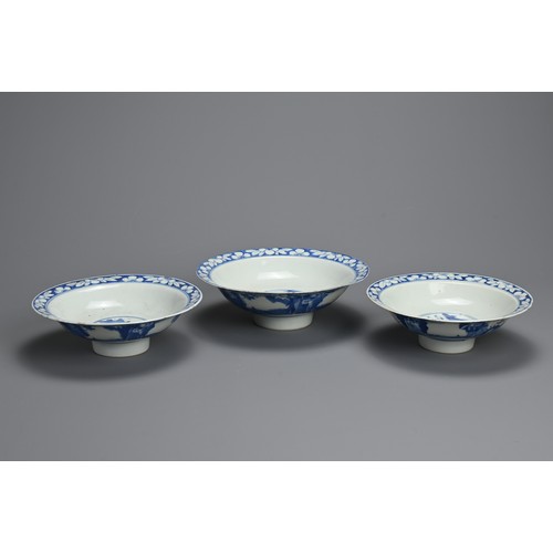 1 - THREE CHINESE BLUE AND WHITE BOWLS, 19TH CENTURY. Shallow rounded sides on a raised foot with everte... 