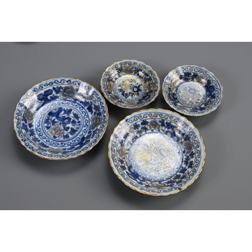 13 - A GROUP OF STRAITS CHINESE NYONYA BLUE AND WHITE GILT DECORATED PORCELAIN ITEMS, 19TH CENTURY. Twelv... 