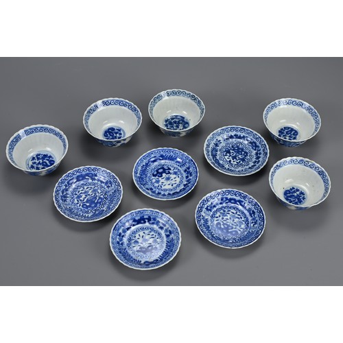 21 - A SET OF TEN CHINESE BLUE AND WHITE PORCELAIN CUPS AND SAUCERS, LATE QING DYNASTY. Ten lobed cups an... 