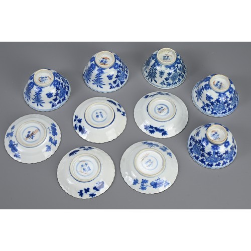 21 - A SET OF TEN CHINESE BLUE AND WHITE PORCELAIN CUPS AND SAUCERS, LATE QING DYNASTY. Ten lobed cups an... 