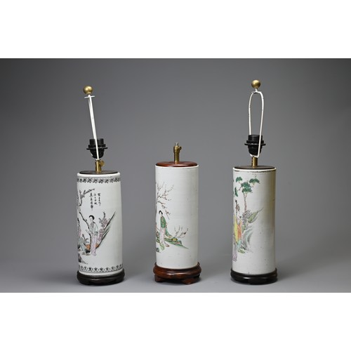 164 - THREE 20TH CENTURY CHINESE PORCELAIN SLEEVE VASES ADAPTED AS LAMPS. The first painted in the famille... 