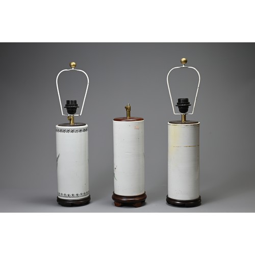 164 - THREE 20TH CENTURY CHINESE PORCELAIN SLEEVE VASES ADAPTED AS LAMPS. The first painted in the famille... 