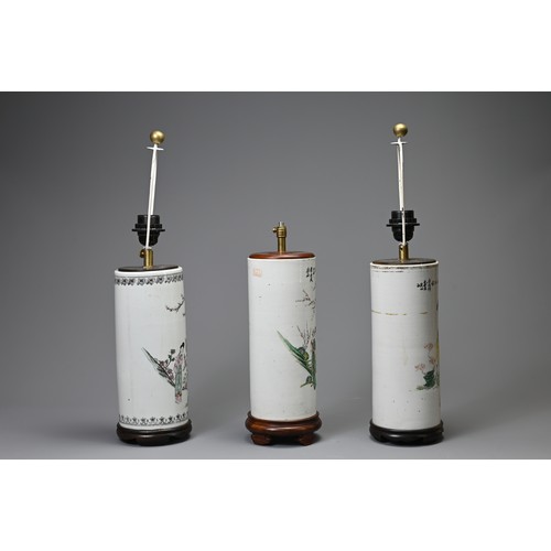 164 - THREE 20TH CENTURY CHINESE PORCELAIN SLEEVE VASES ADAPTED AS LAMPS. The first painted in the famille... 