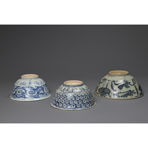 132 - THREE CHINESE PORCELAIN MID-LATE MING DYNASTY BLUE AND WHITE BOWLS. The first painted to the exterio... 